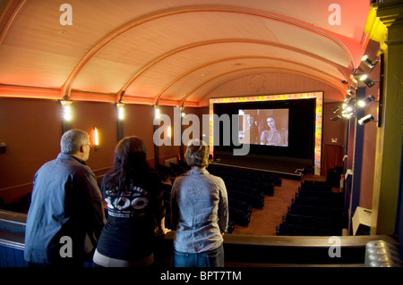 Three cinema goers look at an image from Brighton Rock with Richard Attenborough at a Brighton cinema Stock Photo