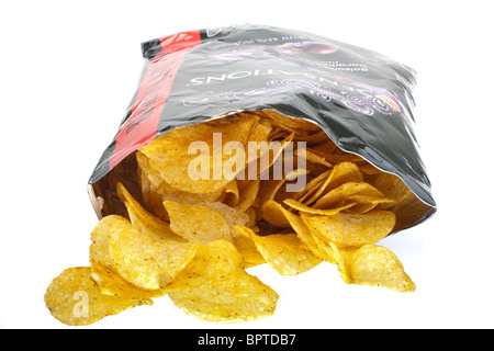 Open bag of crisps spilling onto a white surface Stock Photo