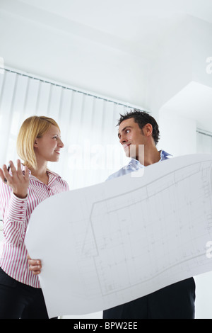 two architects examining blueprint indoors. Copy space Stock Photo