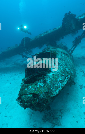 Cameraman filming the wreck of a PBY Catalina seaplane or flying boat underwater, Biak, West Papua, Indonesia. Stock Photo