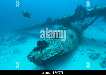 Diver exploring the wreck of a PBY Catalina seaplane or flying boat underwater, Biak, West Papua, Indonesia. Stock Photo