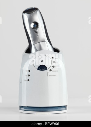 Self cleaning electric shaver with trademarks removed isolated on white background with clipping path Stock Photo