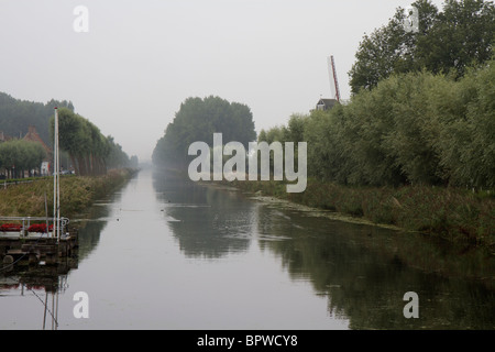 The tree lined Damse Vaart (Bruges-Sluis) canal at Damme in Belgium in the mist Stock Photo