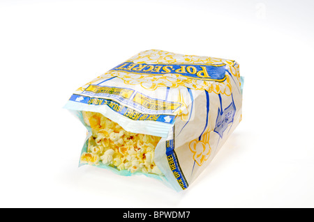 Open bag of Pop Secret microwave popcorn inside microwave with a glass ...