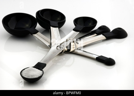 Group of measuring spoons with salt. Stock Photo