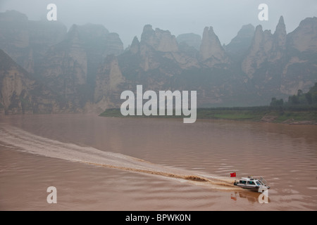 Speed boat on Yellow River near Bingling Si, Gansu Province, China. Stock Photo
