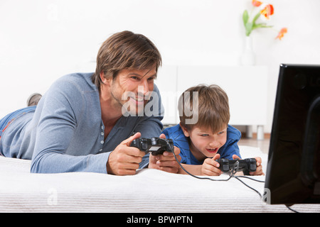 Father and son playing a video game Stock Photo