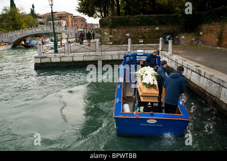 A nun has died in Venice Italy and the special coffin-boat transports the coffin from the city to a waiting hearse Stock Photo