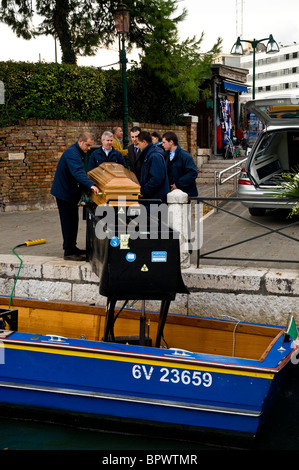 A nun has died in Venice Italy and the special coffin-boat transports the coffin from the city to a waiting hearse Stock Photo