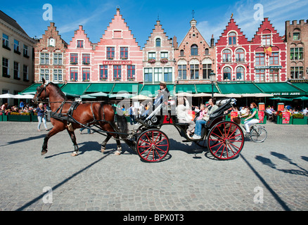 Tourists enjoying tour of Bruges in Belgium on horse drawn carriage Stock Photo