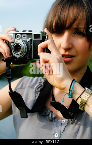 Young English woman holding a vintage Zeiss Contessa 35 camera Stock Photo