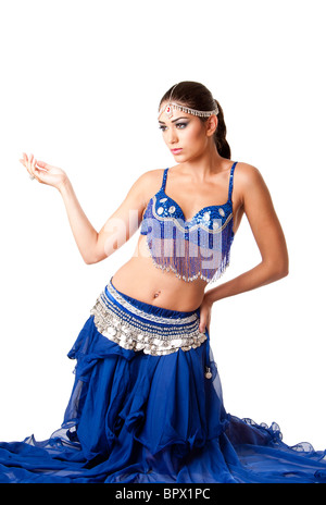 Beautiful Israeli Egyptian Lebanese Middle Eastern fashion belly dancer performer in blue skirt and bra sitting on knees. Stock Photo