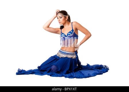 Israeli Egyptian Lebanese Middle Eastern fashion belly dancer performer in blue skirt and bra with hand holding head. Stock Photo