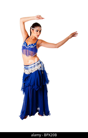 Arabic belly dancer harem woman in blue with silver dress and head jewelry with gem dancing swirling her arms. Stock Photo