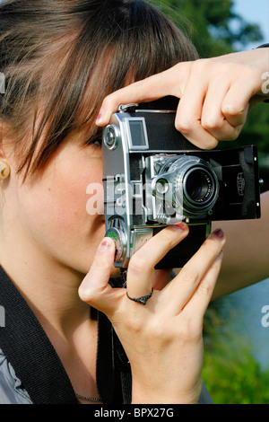 Young English woman holding a vintage Zeiss Contessa 35 camera Stock Photo