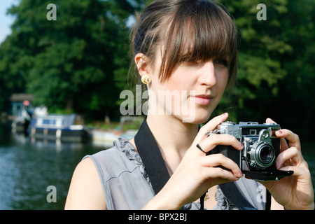 Young English woman holding a vintage Zeiss Contessa 35 camera Stock Photo