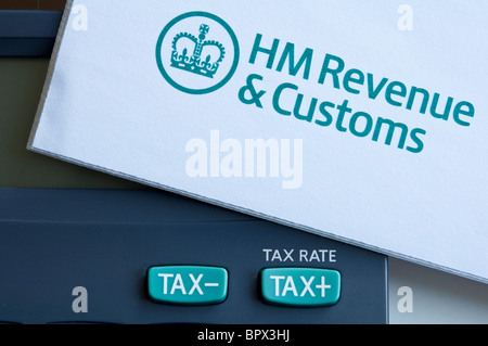 Close up of 'Tax' ( +/- ) keys on a calculator and a UK, HMRC Tax Form. Stock Photo