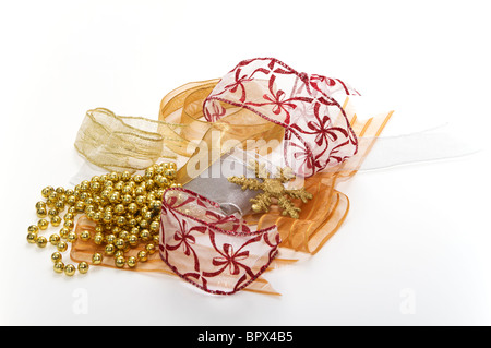 Fancy ribbons for Christmas wrapping with decorations in red, gold, and silver. Stock Photo