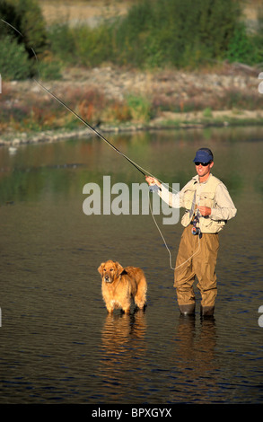 Man and dog fly fishing on Silver Creek, Idaho Stock Photo