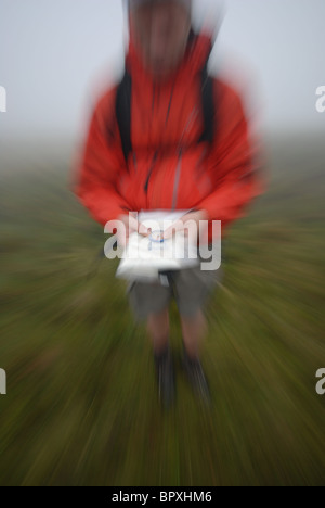 Micro navigtation in the mist on the featureless Ulpha fells, of the Lake District, UK Stock Photo