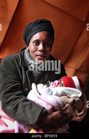 Mother with her baby in their hut in a Township in the vineyards of De Doorns, Western Cape, South Africa, , Hex Valley Stock Photo