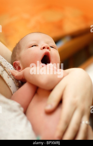 portrait of crying newborn baby in mother's hands Stock Photo