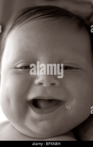 Baby (up to 18 months) smile and drools. Stock Photo