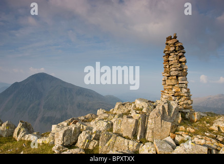 Tall cairn on Lingmell, in the Lake District, Cumbria, looking towards Great Gable. Stock Photo