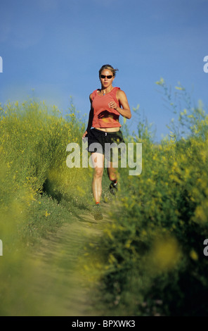 A woman running on the Lefthand trail near Boulder, CO. Stock Photo