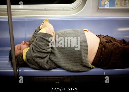 The feet of a homeless man sleeping on a bench at the National Mall in ...