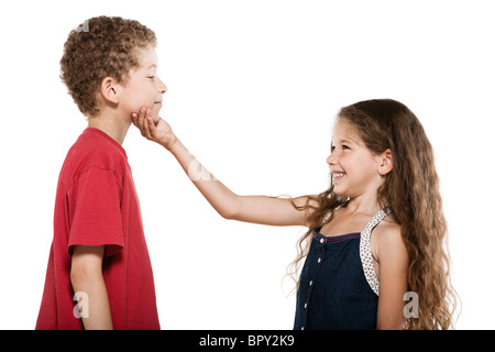 caucasian little boy and girl portrait sibling complicity isolated studio on white background Stock Photo