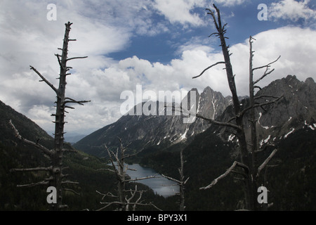 Mirador L'Estany Sant Maurici lake and Els Encantats mountain peak on Pyrenean Traverse National Park Pyrenees Spain Stock Photo