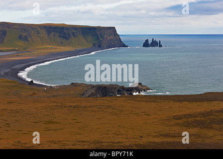 Black sand at Reynisfjara Beach on the South Coast of Iceland, showing Reynisdrangar sea stacks, Iceland Stock Photo