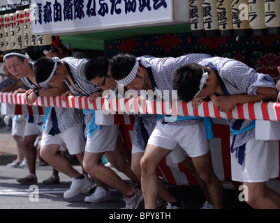 Young men pushing the floats at Nebuta Matsuri summer festival of giant floats, Aomori City, Aomori Prefecture, Japan Stock Photo