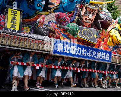 Young Japanese men pushing a float at Nebuta Matsuri summer festival of giant floats, Aomori City, Aomori Prefecture, Japan Stock Photo