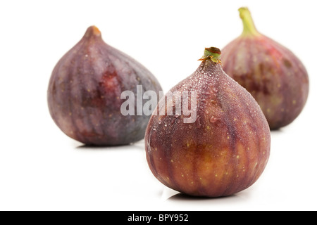 wet fig in front of two figs on white background Stock Photo