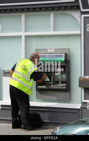 ATM sanitising at a bank in a U.K. city. Stock Photo