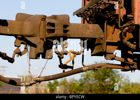 Steel couplers connect two railroad freight cars. Stock Photo