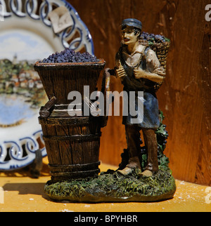 French Christmas figurine caganers relating to the wine industry on sale in a shop window Stock Photo
