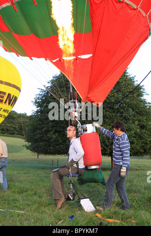 Hot air ballooning pilot of a single one man balloon with no basket prepares for flight in Somerset England UK Stock Photo