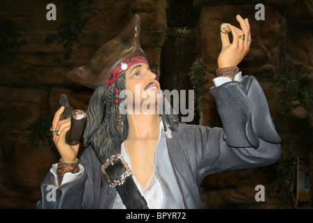 Model Of A Pirate Holding Gold Treasure Coin Stock Photo