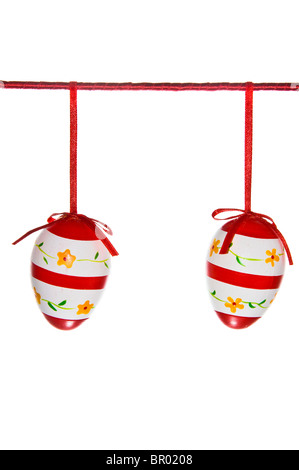 Two easter eggs hanging on a red line isolated on white Stock Photo