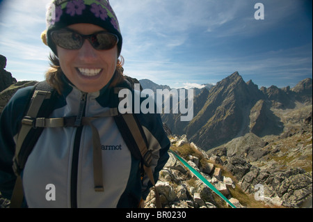 Femal hiker smiling on top of the High Tatra Mountains, Slovakia Stock Photo