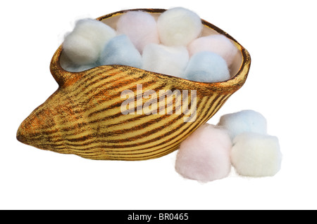 Periwinkle filled with colored cotton balls spilled Stock Photo
