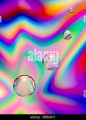 Abstract image of drops of water coloured by cross polarisation. Stock Photo