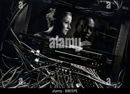 A caucasian woman and an African American man work on a project of developing new technology/software. Stock Photo