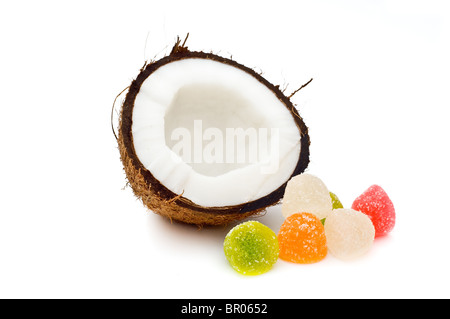 Halved coconut with jelly candies isolated on white Stock Photo