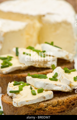 Delicious cream cheese on fresh sliced bread with chives Stock Photo