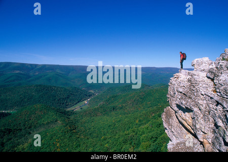 Male backpacker takes in the view from a rocky overlook along the North Fork Mountain Trail near Seneca Rocks, WV Stock Photo