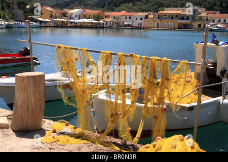 Fishing nets, Lakka harbour, Paxos, Ionian Island, Greece. Yellow fishing nets hanging out to dry or repair. Stock Photo